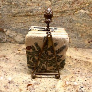 Four Pottery Coasters in Metal Stand